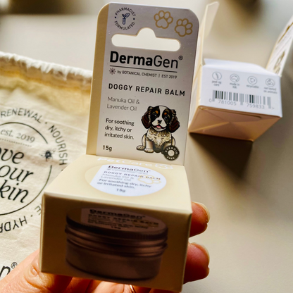 DermaGen doggy repair balm packaging held by a hand on a light background