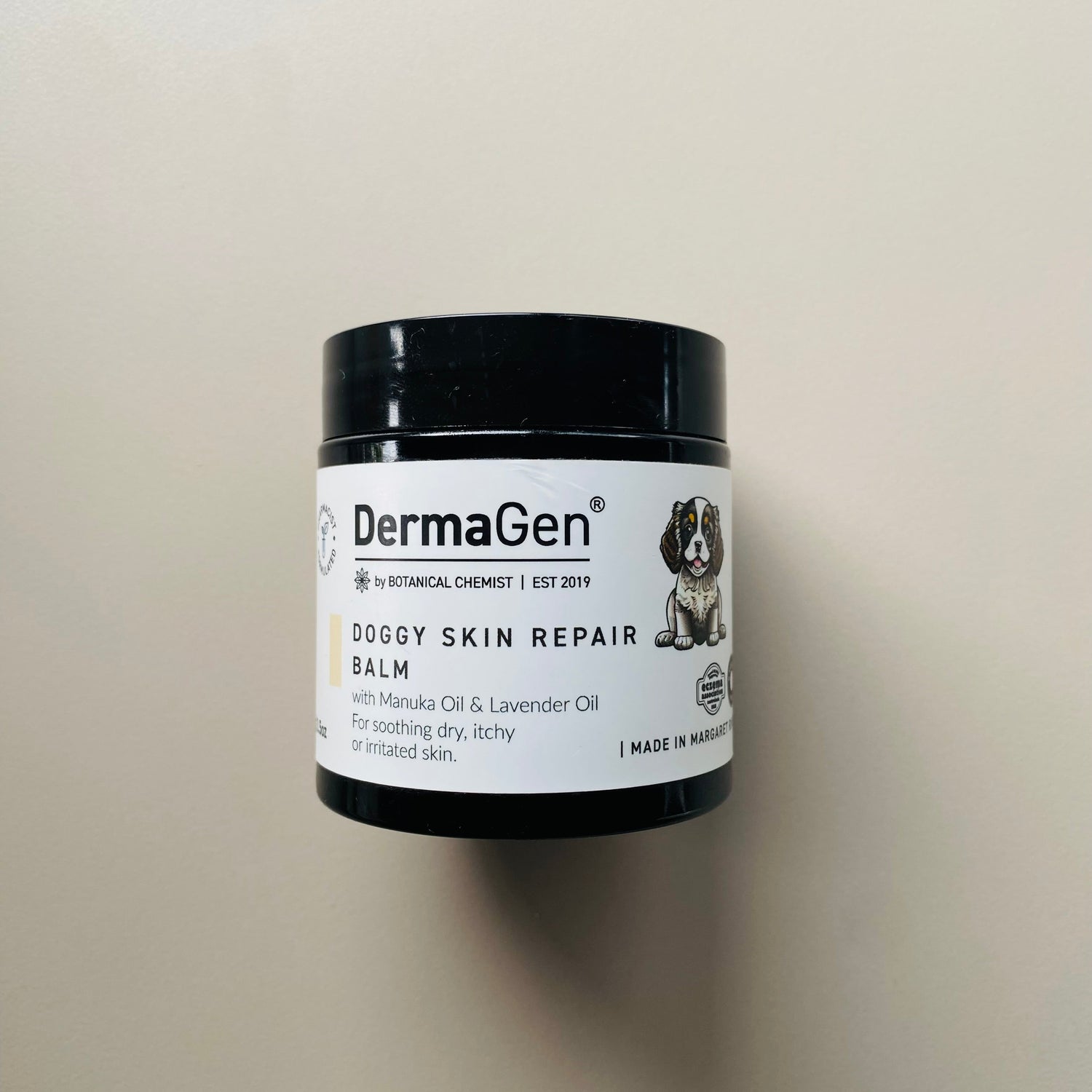DermaGen Doggy Skin Repair Balm jar on a beige background