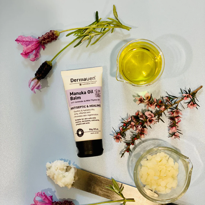 Dermagen Manuka Oil Balm with manuka oil and flowers on a white background