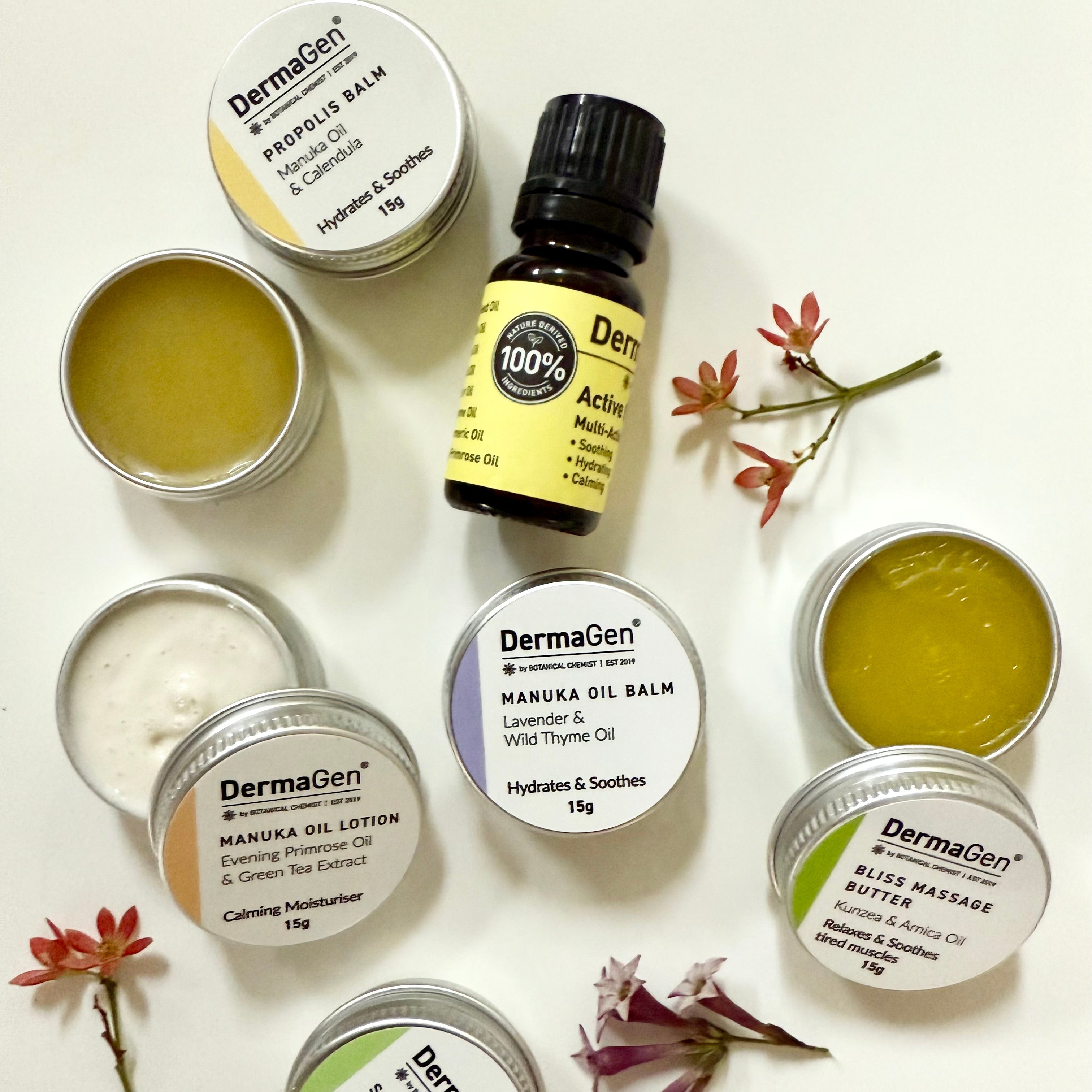 Collection of DermaGen skincare products including oils, balms, and a bottle on a light background with flowers.