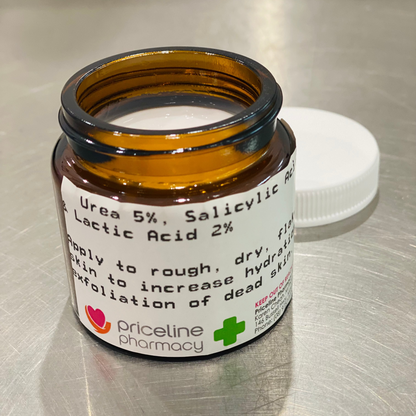 A small brown jar with a white lid labeled as &